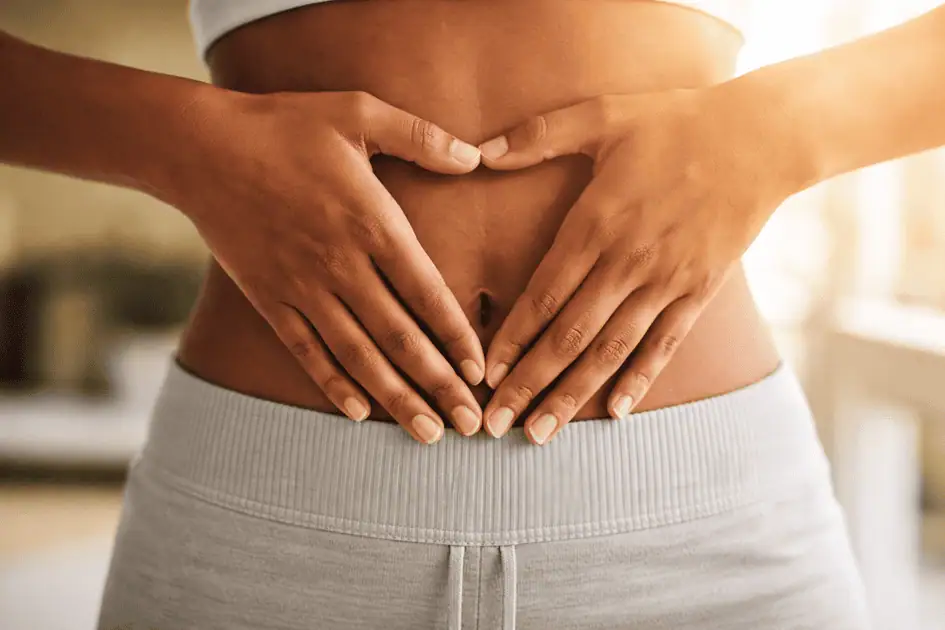 Woman holding stomach symbolizing gut and hormone balance